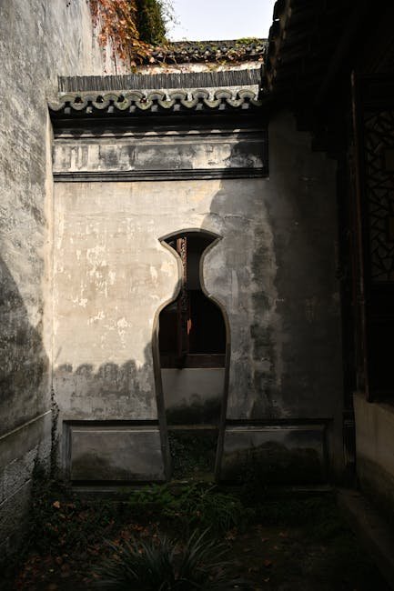 Traditional Chinese screen wall with decorative brick carving at a courtyard entrance